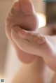 A close up of a person's foot with a pair of white socks.