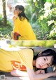 A woman in a yellow shirt laying on a wooden bench.