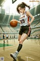 A woman holding a basketball on a basketball court.